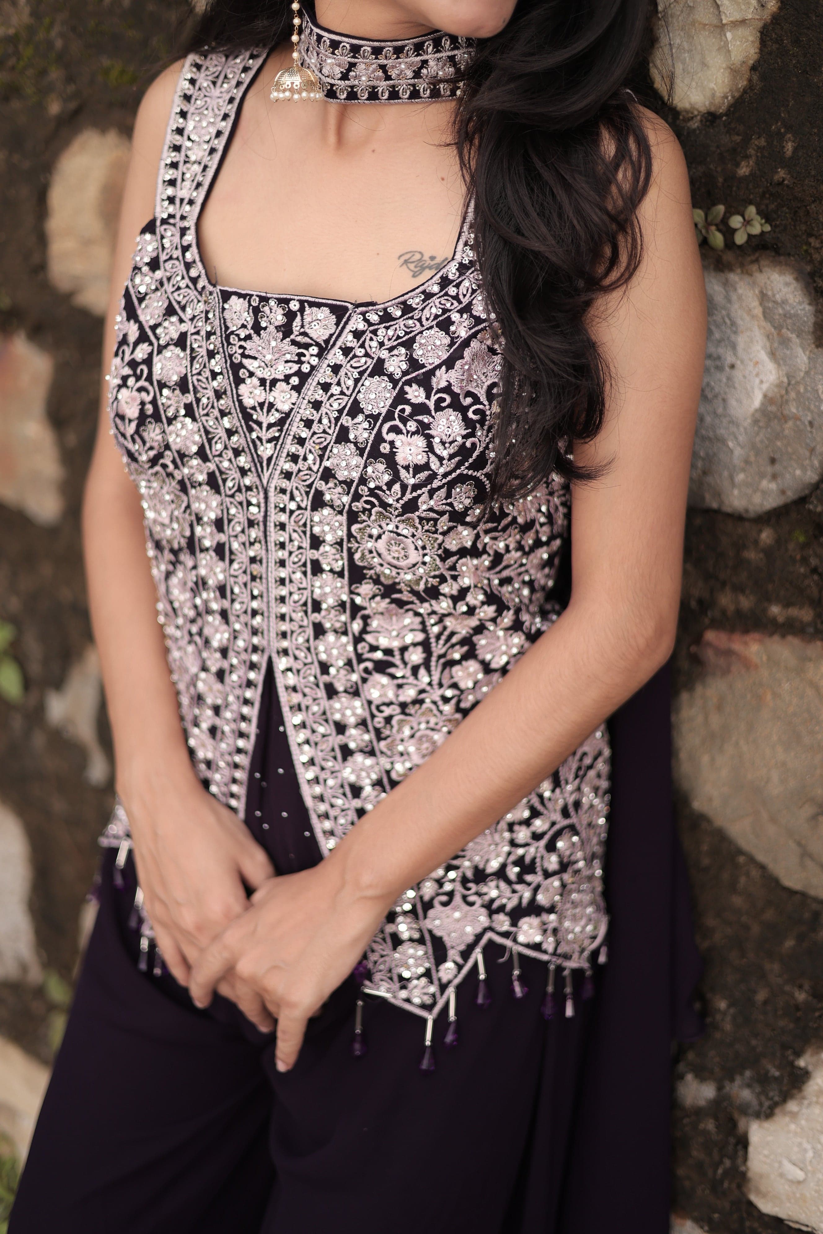 Person wearing a patterned dress lying on a stone surface