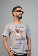 Person wearing a graphic t-shirt with a plant in the foreground