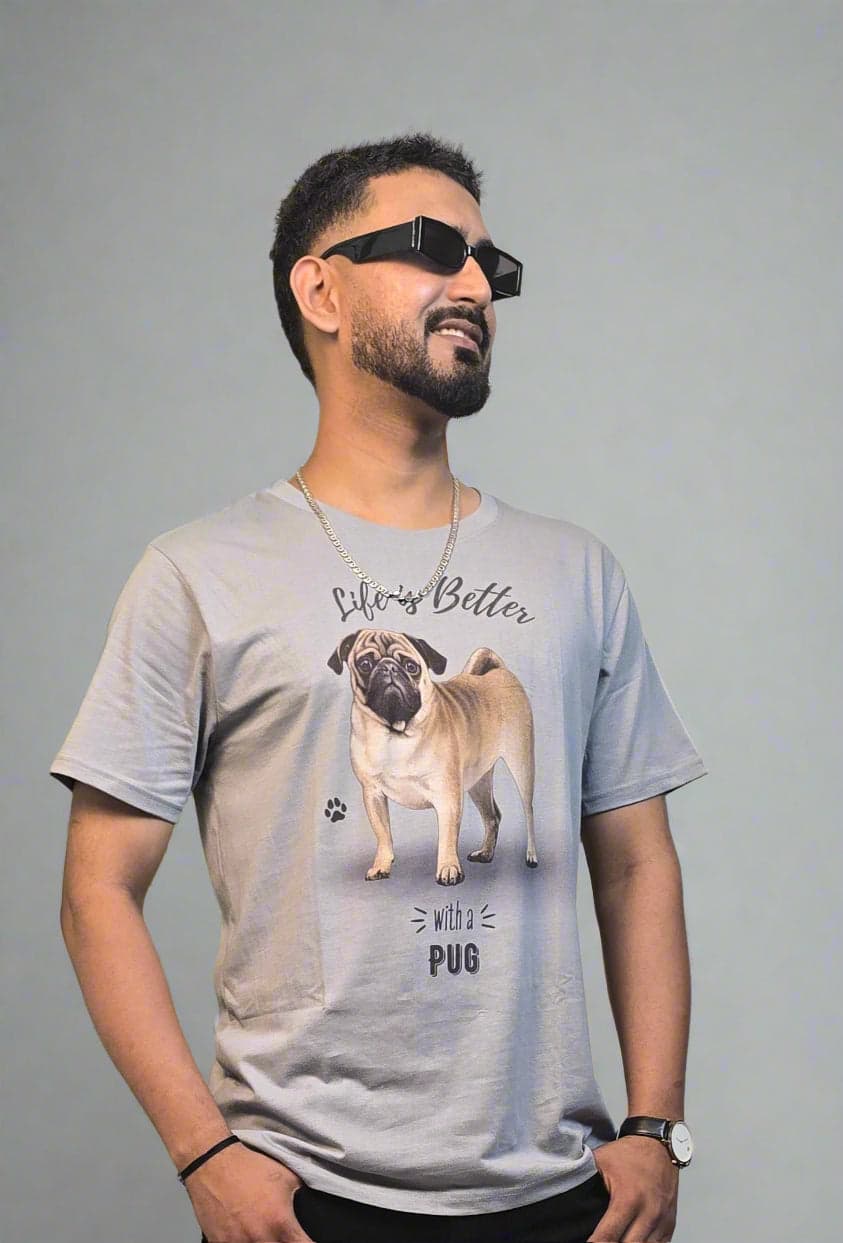 Person wearing a graphic t-shirt with a plant in the foreground