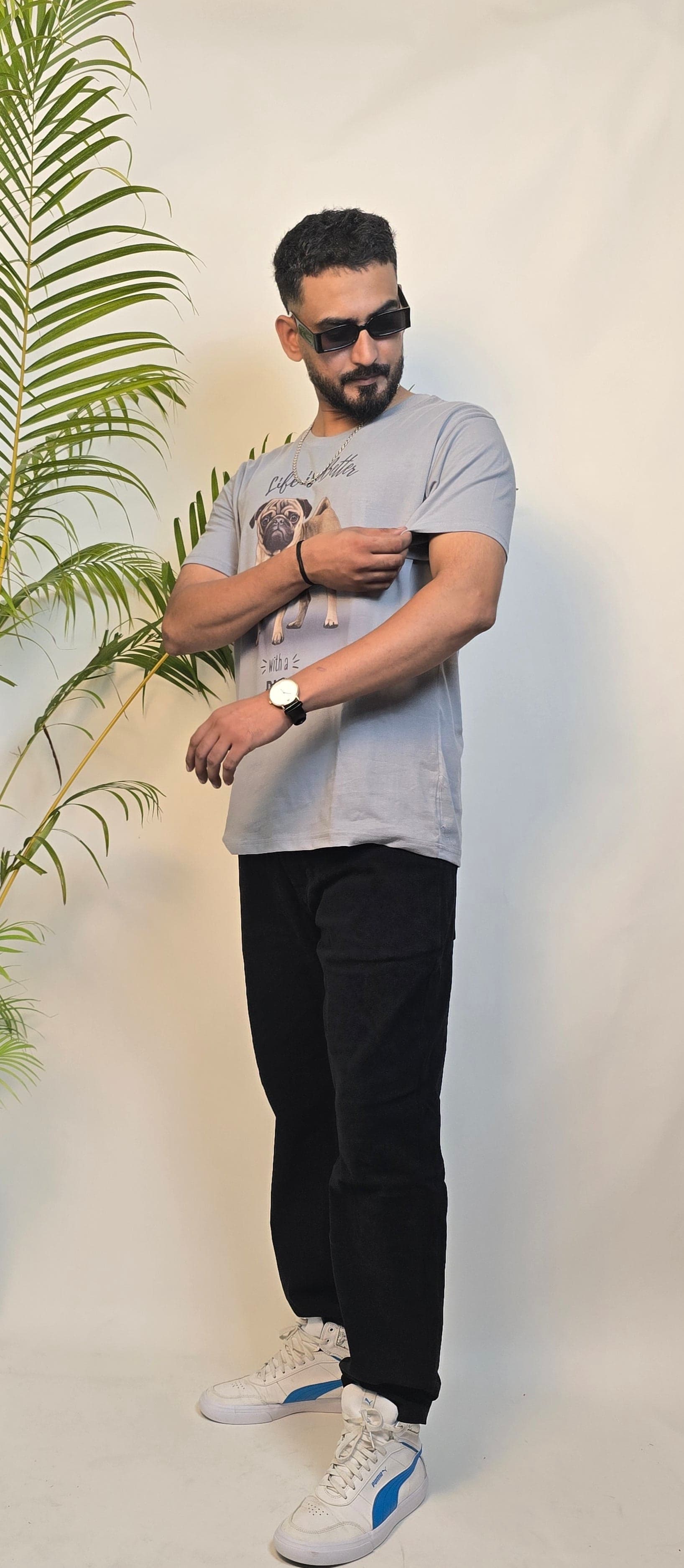 Man standing next to a plant on a white floor