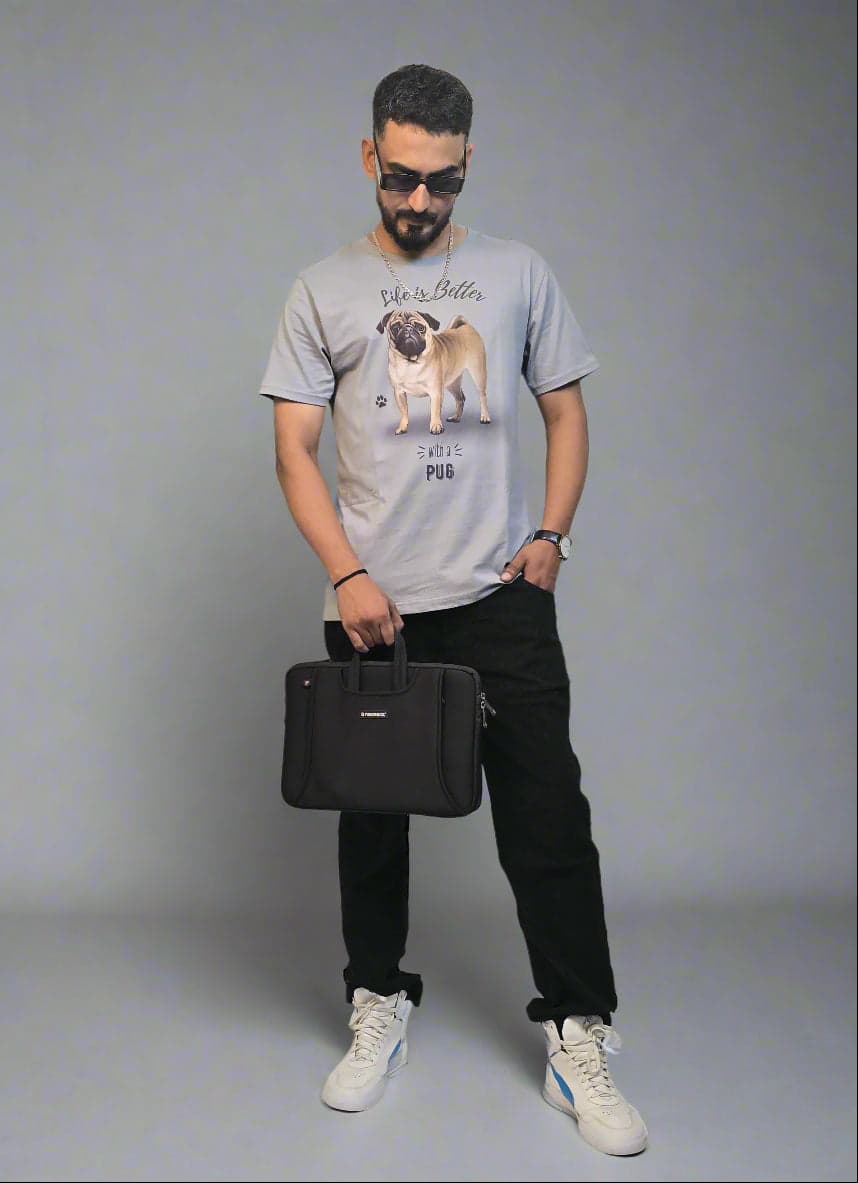 Person holding a black bag in a minimalistic indoor setting with plants.