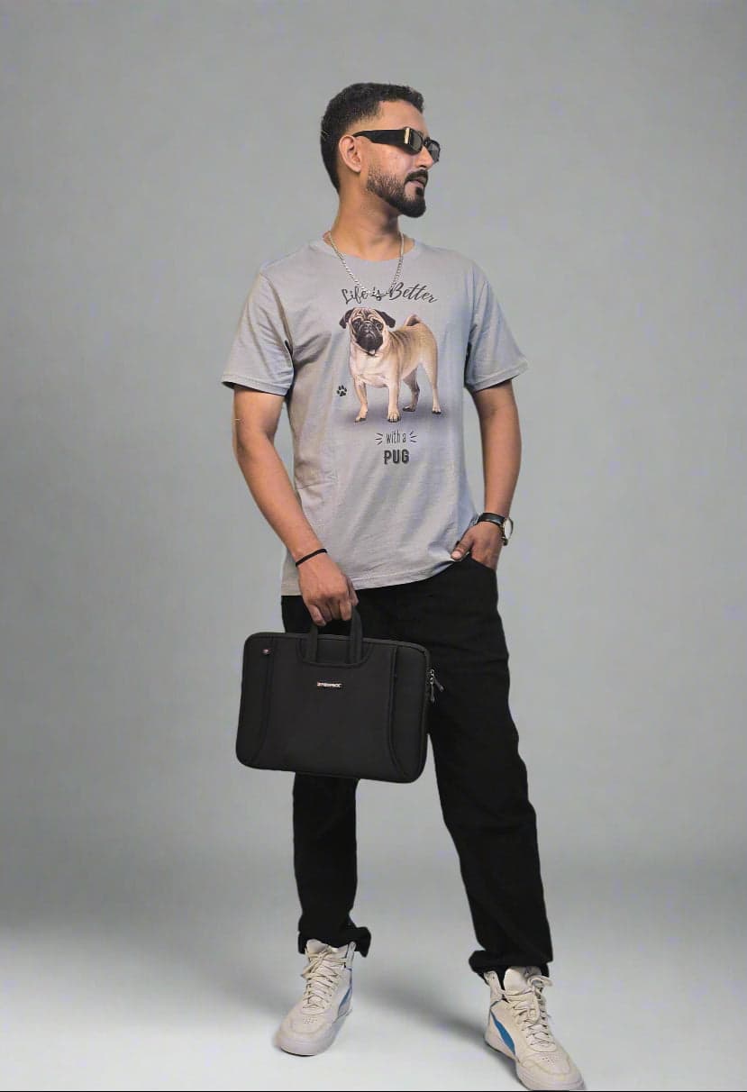Person holding a black bag in an indoor setting with plants and a white wall.