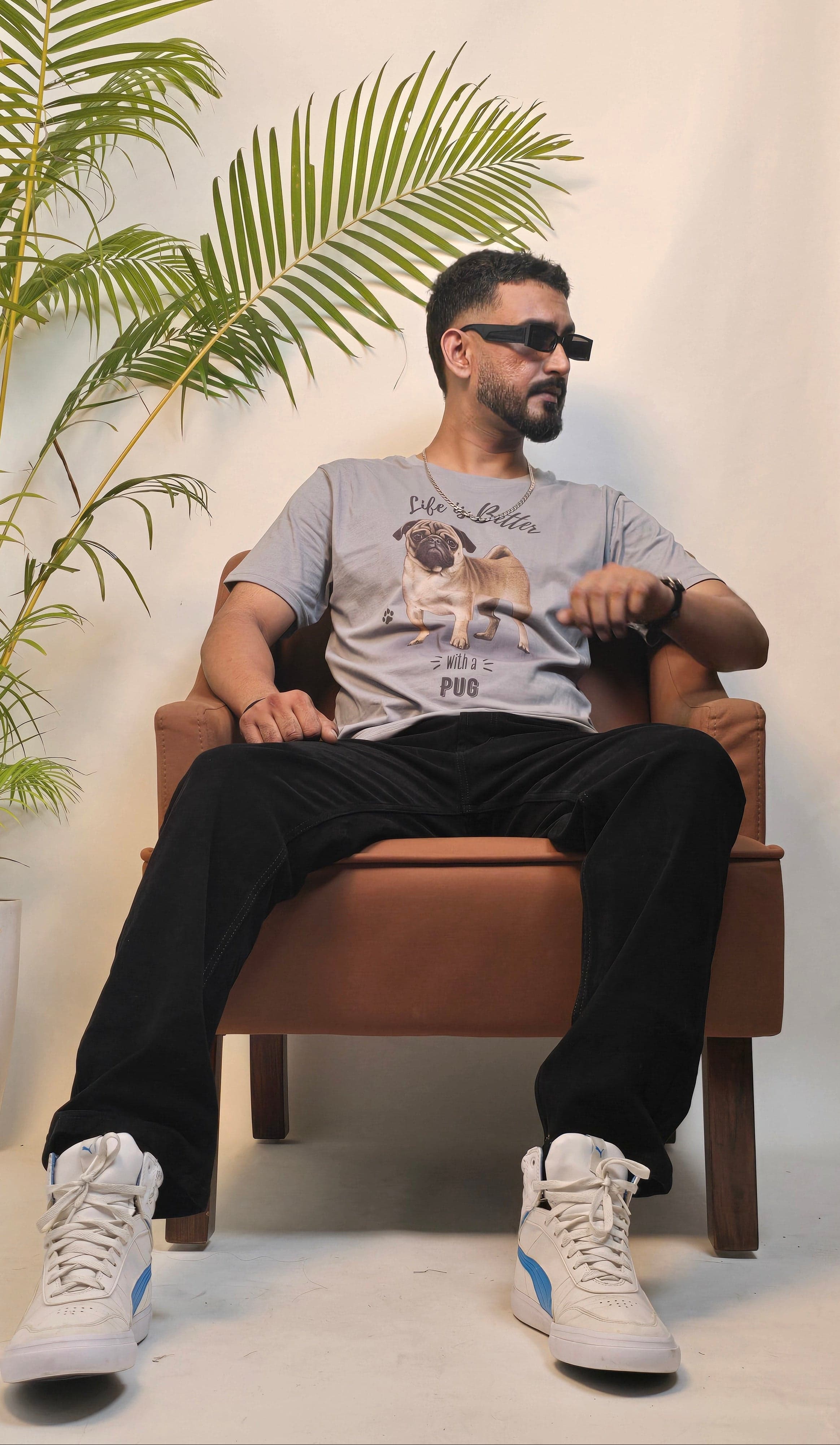 Person sitting on a bench with a plant in the background